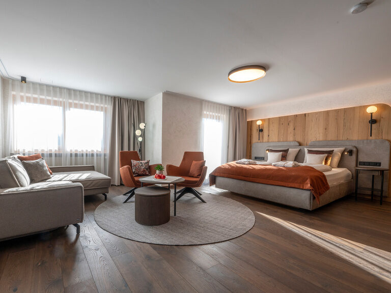 Stilvoll dekorierter Wohnbereich in der Suite-Typ 3A des Hotel Mooshof in Bodenmais mit einladendem Ambiente für Erholung und Ruhe.